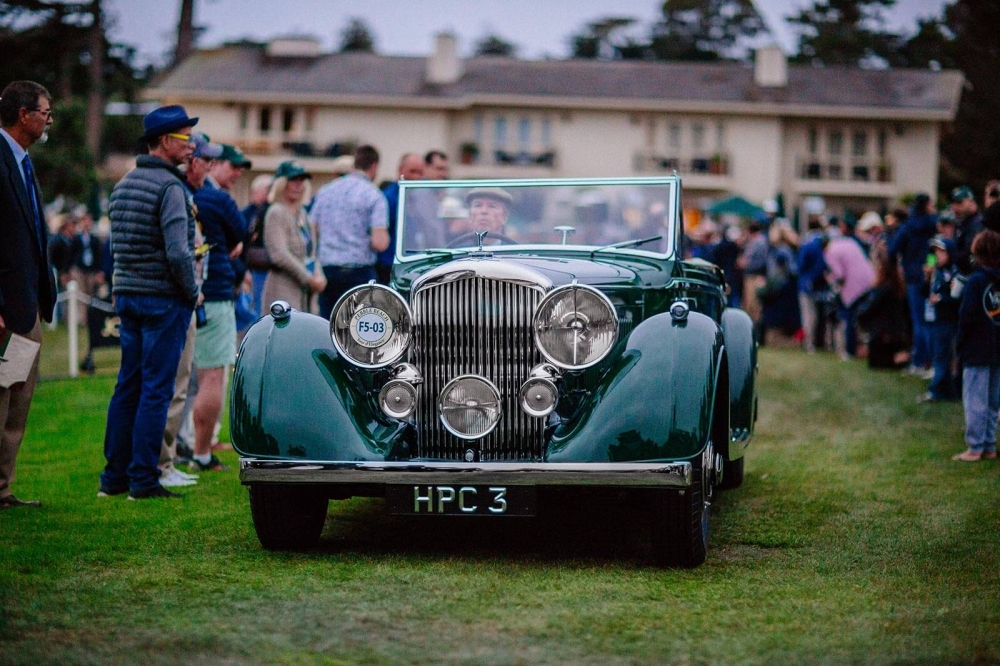 A Pebble Beach Concours entrant driving onto the show field at Dawn Patrol presented by Hagerty