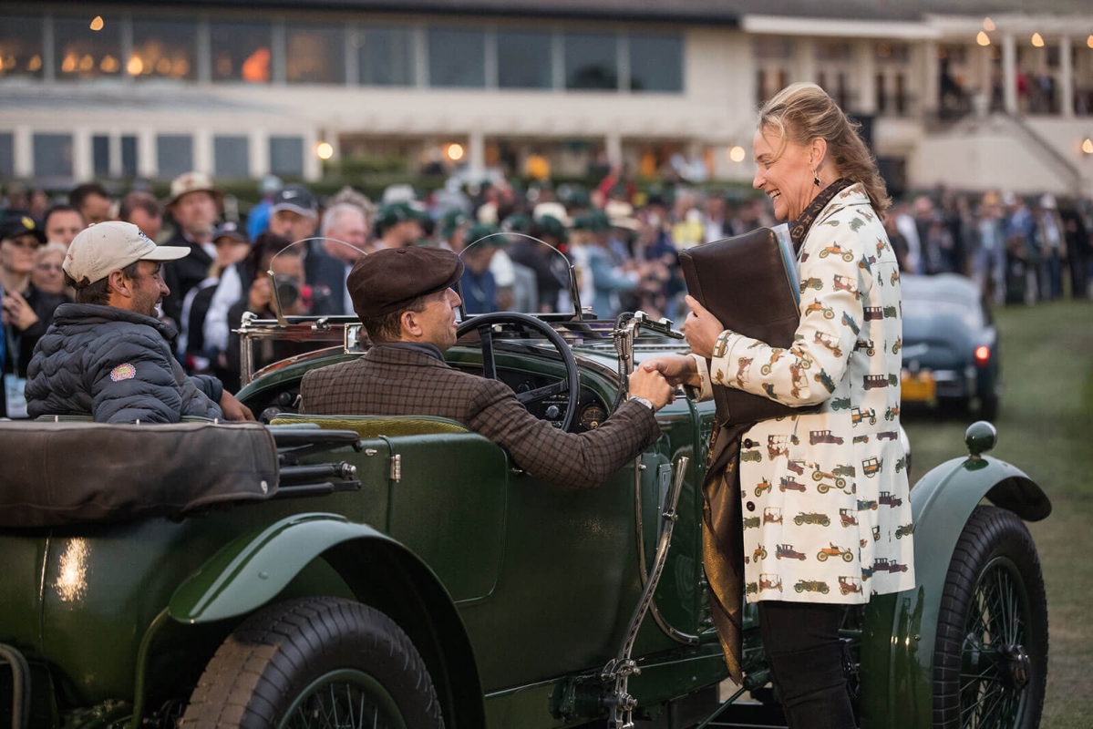 Chairman Sandra Button greeting entrants at Dawn Patrol presented by Hagerty